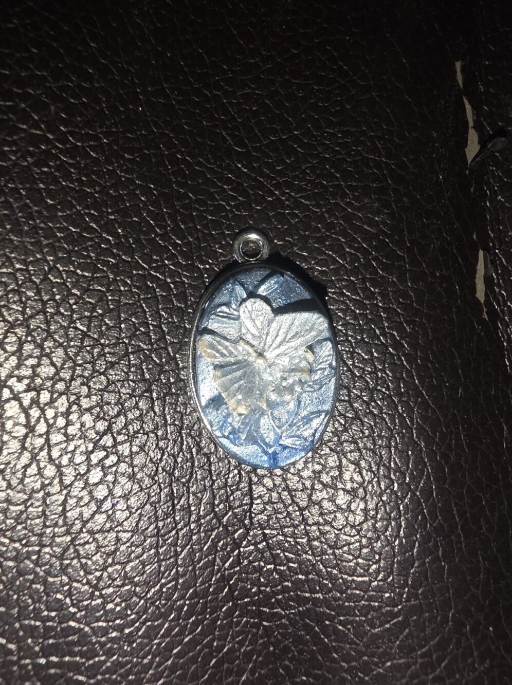Small Blue Resin Butterfly Pendant With Floral Accents On A Silver Tone Bezel